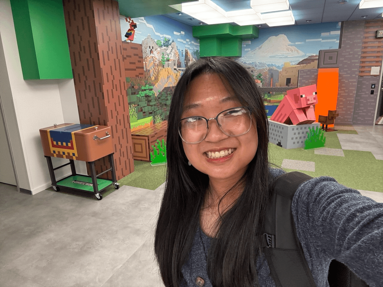 Sophia smiling in a Minecraft-themed room